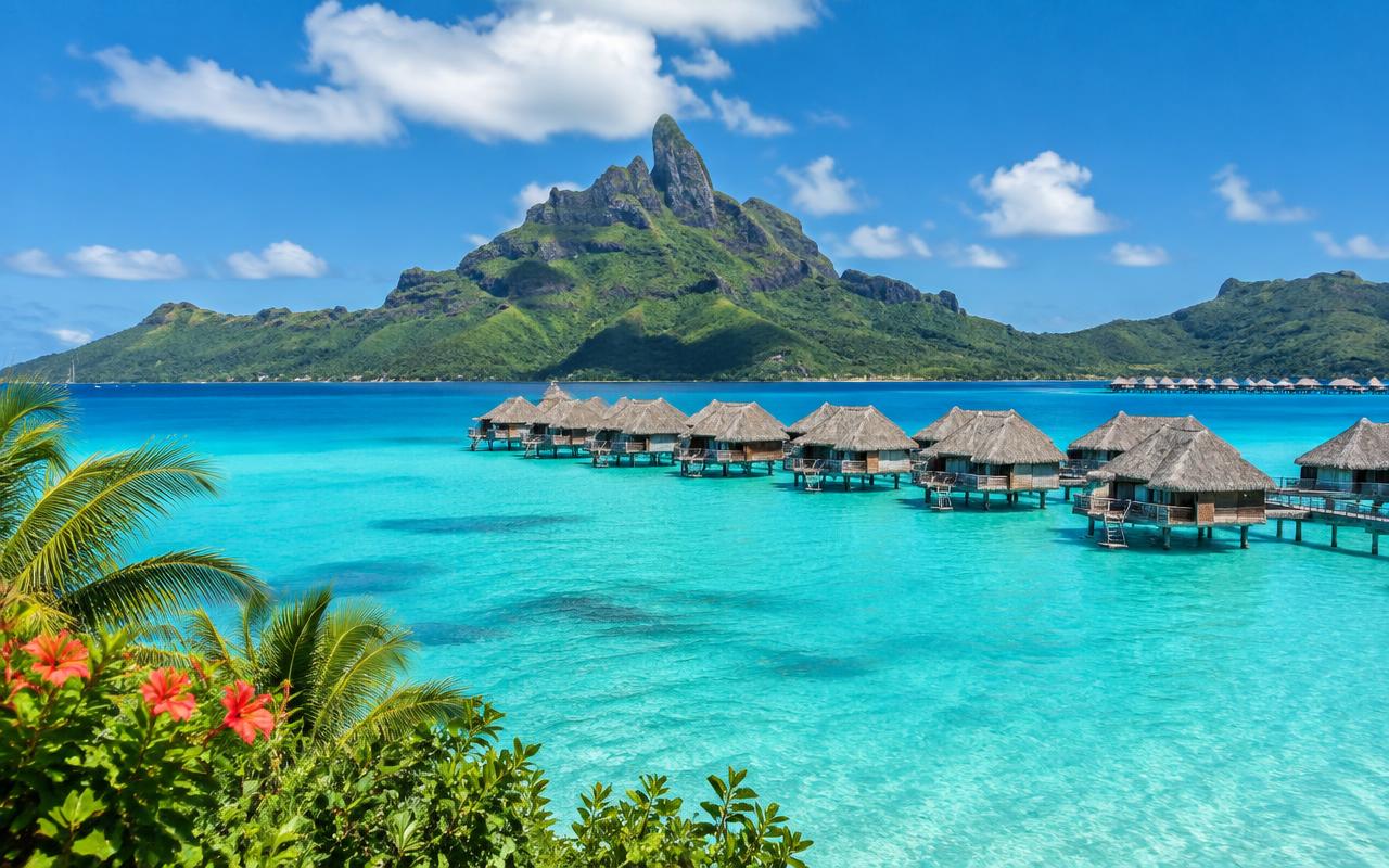 Mount Otemanu above the Bora Bora lagoon with overwater suites along the reef, French Polynesia